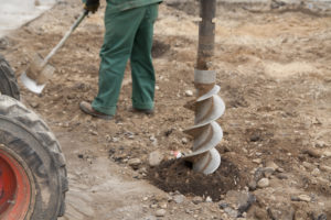 A drilling rig creating a hole in the ground